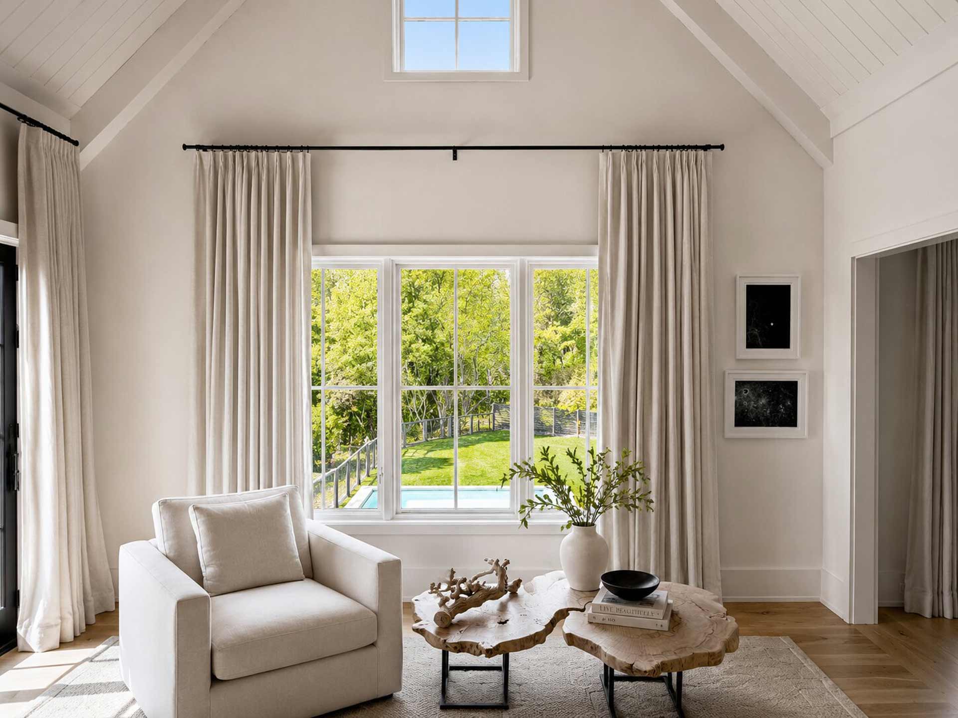 two pieces of art hanging in a modern living room with natural light.